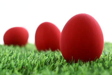 Fototapeta na wymiar red easter egg on lawn green grass artificial with blank white background