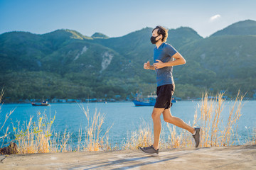 Runner wearing medical mask, Coronavirus pandemic Covid-19. Sport, Active life in quarantine surgical sterilizing face mask protection. Outdoor run on athletics track in Corona Outbreak. Keep your
