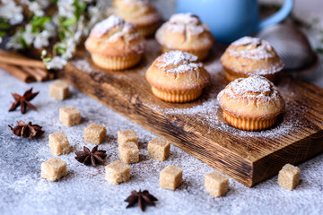 Fresh baked cupcakes of rice flour with banana and vanilla with a mug of hot chocolate