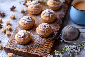 Fresh baked cupcakes of rice flour with banana and vanilla with a mug of hot chocolate