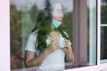 Woman wear a mask stay at home prevent the spread of the coronavirus (covid 19)