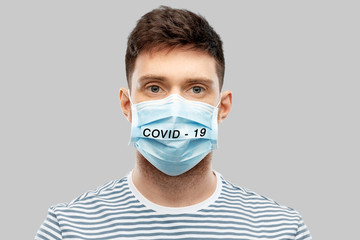 health protection, safety and coronavirus epidemy concept - young man in face protective medical...