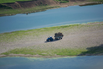 river tractor haystack summer grass meadow