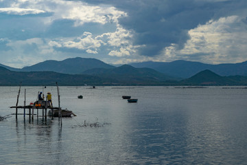 Fototapeta na wymiar Fishing men working at the river nha trang, vietnam, asia