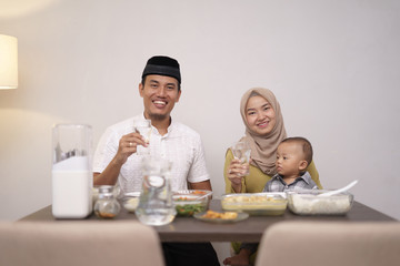 muslim family breaking the fast on ramadan kareem. islam dinner after fasting