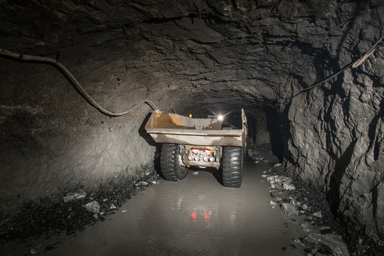 Dumper truck Minetruck Sandvik Toro Atlas Copco in underground mine tunnel
