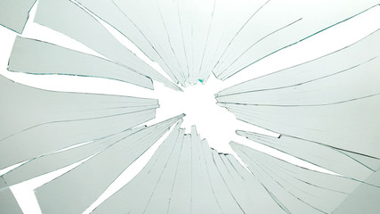 Broken and cracked glass with hole on a white background