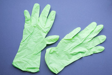 green gloves isolated on blue background, health care protection for corona virus, 