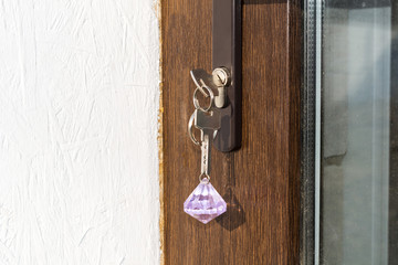 Open door with keys, key in keyhole, bedroom in background