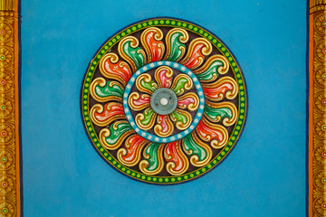 Ceiling of Meenakshi Sundareswarar Temple in the South India, beautiful vintage ceiling paintings with pattern and lamp in the center in an Indian temple