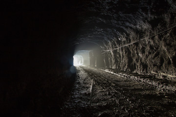 Underground magnezite mine tunnel with fog and light