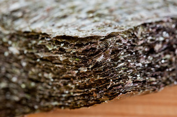 Nori seaweed dried in flat sheets. For making sushi, rolls and other dishes. Background for asian food.