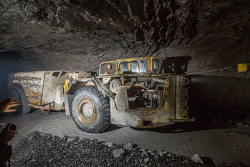 Dumper truck Minetruck Sandvik Toro Atlas Copco in underground mine tunnel