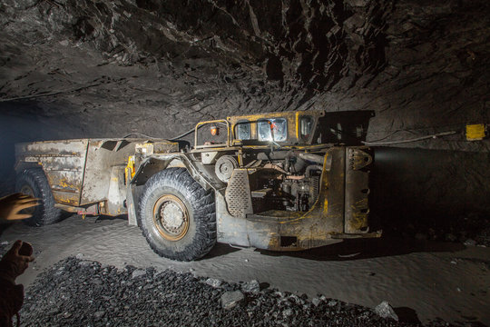 Dumper truck Minetruck Sandvik Toro Atlas Copco in underground mine tunnel