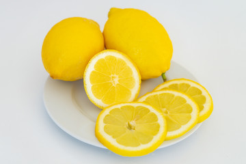 Lemon on a plate close-up on a black background. Alternative medicine. Food protection against viruses, coronavirus, immunity concept.