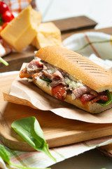 Sandwich panini version, long baked beef meat, pulled in fresh baquette with fresh salad and hot sause