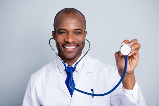 Photo of family doc dark skin guy hold stethoscope listen heart rate beating patient virologist check tourists china corona virus symptoms wear lab coat tie isolated grey color background