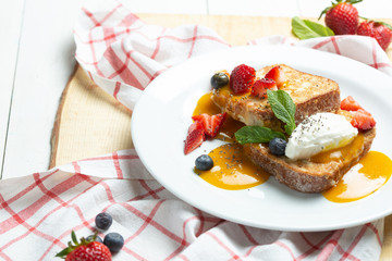 Toast with cream, strawberry and milk souse. Sweet breackfast