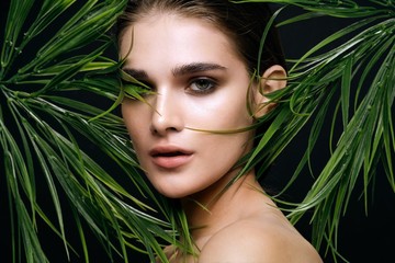 Naklejka premium beautiful woman green leaves nature rest