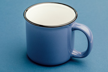 Empty iron mug, on a blue background.