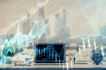 Forex graph hologram on table with computer background. Multi exposure. Concept of financial markets.