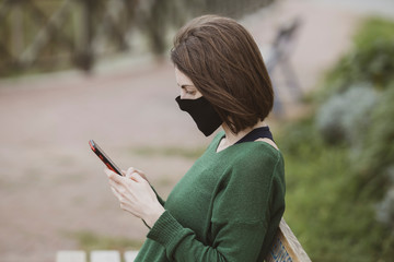 a woman talking on the phone with coronavirus mask