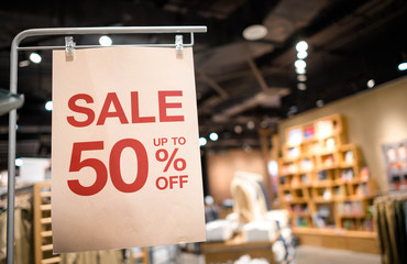Discount percentage sign display in  fashion department store during sale season period.