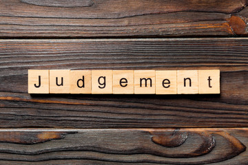 judgement word written on wood block. judgement text on table, concept