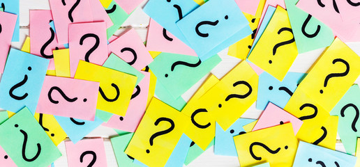 colorful paper notes with question marks. Closeup