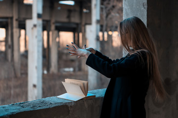 girl sorceress leafing through a book of spells