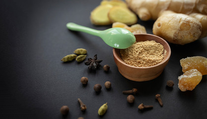 Ginger root, spices on a black background. The concept of healthy nutrition, protection from viruses, increased immunity during coronavirus quarantine, super nutrition. Selective focus.