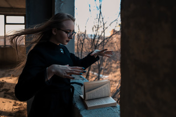 girl sorceress leafing through a book of spells