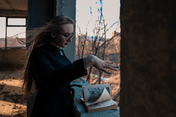 girl sorceress leafing through a book of spells