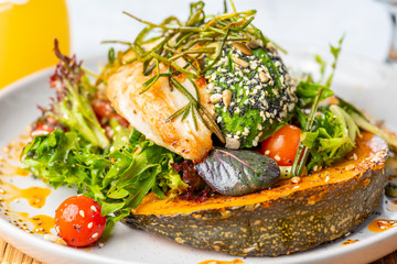 A serving of Warm Chicken and Avocado Salad, with Roasted Pumpkin and 5 Seed.