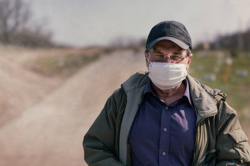 Fototapeta na wymiar Sixty year old man in quarantine medical mask