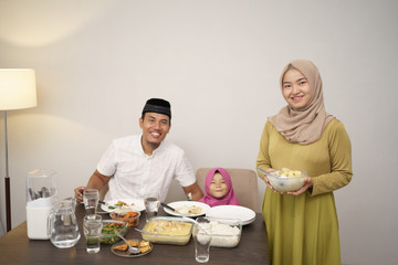 beautiful muslim family having dinner together. breakfasting concept during ramadan kareem