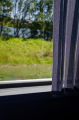 Blinds on window of tour bus looking outside