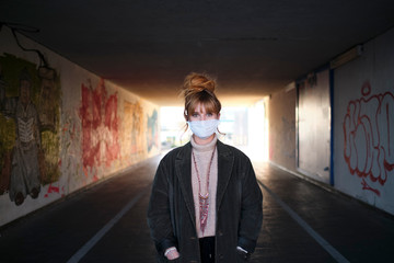 Woman wearing medical mask while sunset- Stop spreading Coronavirus.