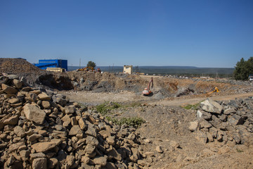 Excavator in open pit chrome ore quarry mining