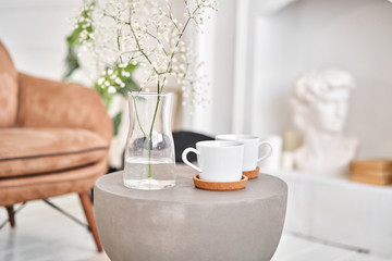 White cups on a concrete table. two cups of hot coffee. Concept of renting an apartment or bed and Breakfast