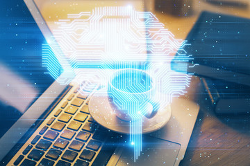 Double exposure of work space with computer and human brain drawing hologram. Brainstorm concept.