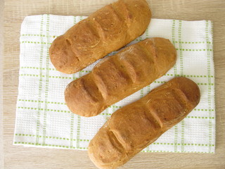 Freshly baked baguette on a dishtowel