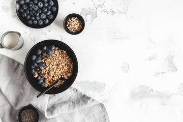 Breakfast with muesli, blueberry, coffee on white background. Healthy food concept. Flat lay, top...