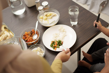 close up of hand serving some food for early breakfast before dawn