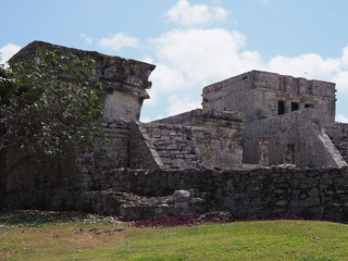 Stony temple of god of winds at TULUM city at Mexico on grassy field