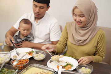 muslim family with toddler breakfasting during ramadan kareem at home together