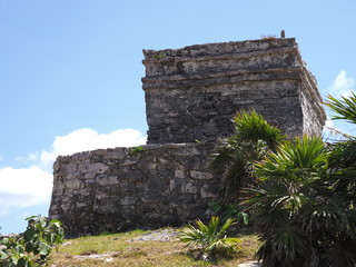 Famous temple of god of winds at TULUM city at Mexico on grassy field