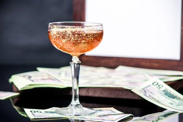Cocktail on a dark background with money and decor