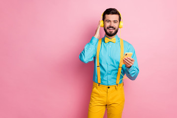 Portrait of his he nice attractive cheerful cheery bearded guy meloman wearing mint shirt listening pop stereo sound enjoying leisure spending free time isolated over pastel pink color background
