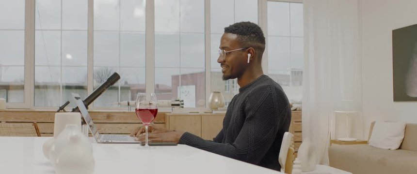 Black male having a glass of wine during a video call with friends or family. Stay home, quarantine social distancing. ARRI Alexa Mini